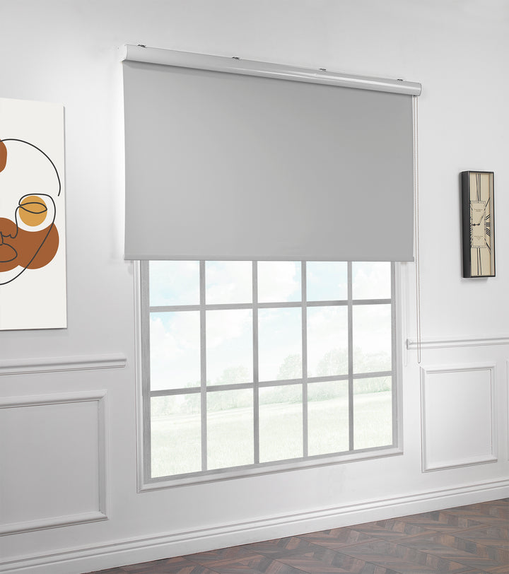 A made to measure light grey room darkening roller blind shown lowered with a smooth matte texture and clean minimal edges