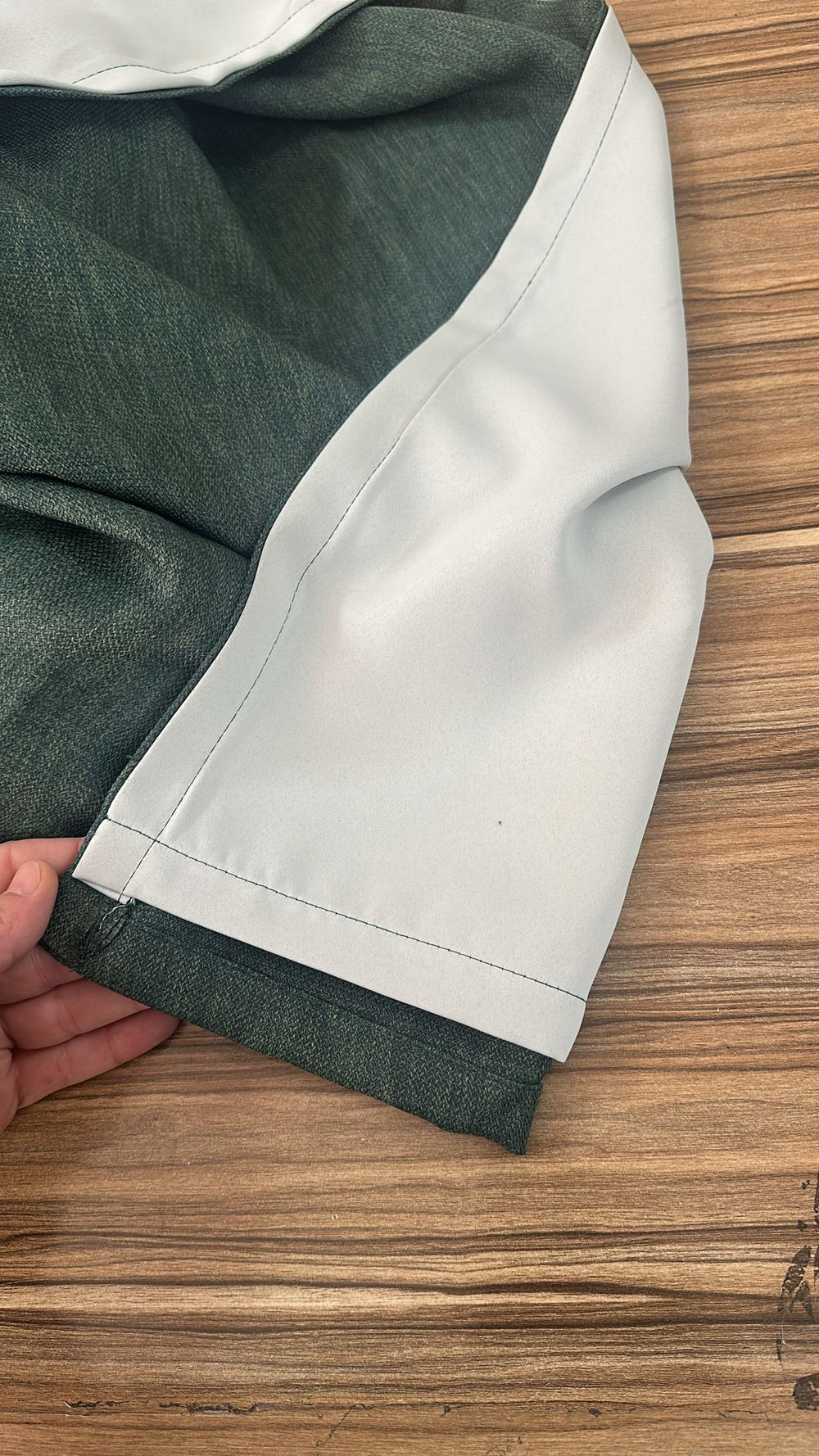 Close-up of green curtains and add lining for blackout