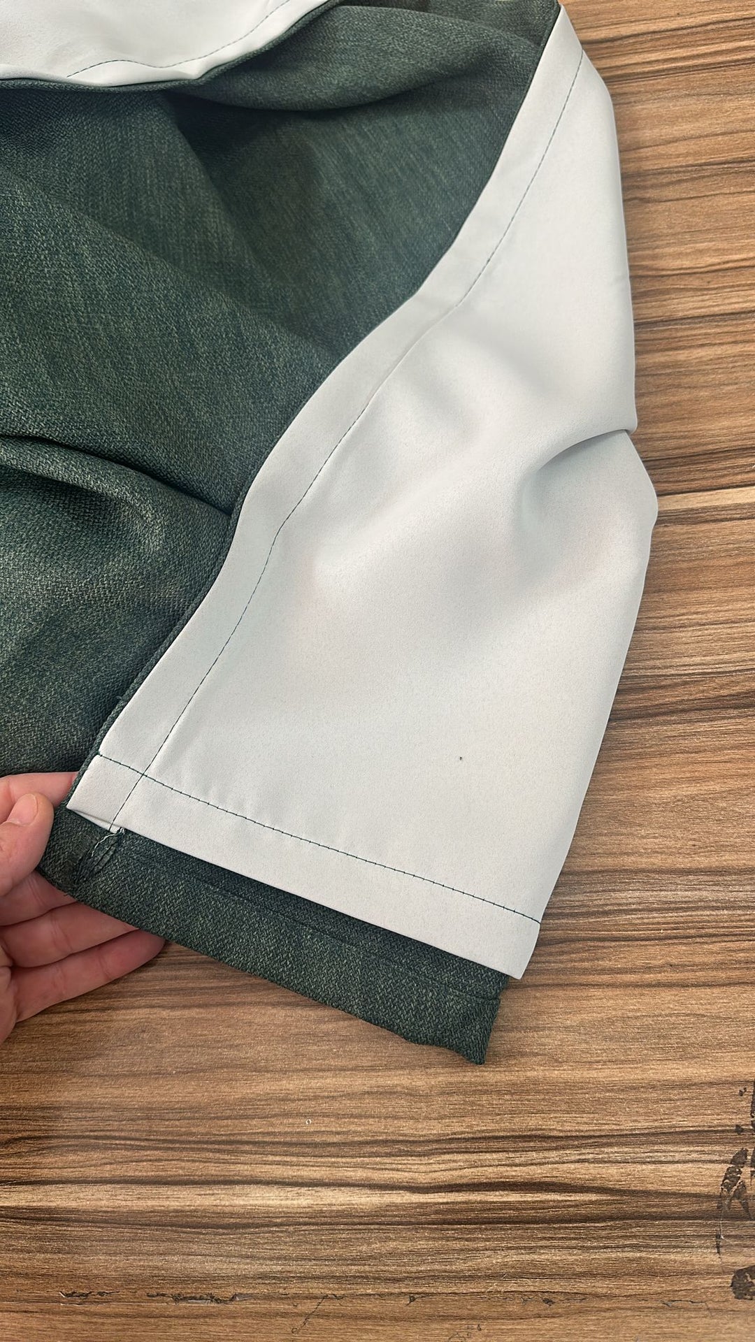 Close-up of green curtains and add lining for blackout