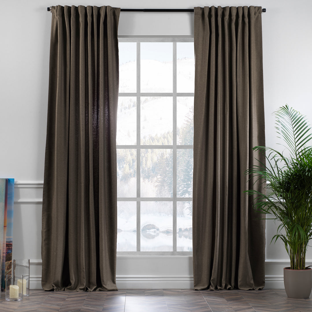 A made to measure linen‑look curtain in mink, shown in daylight with soft neutral texture and a refined flowing drape