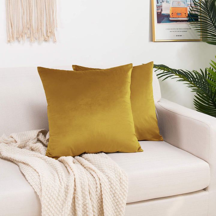 A made to measure cushion cover in warm marigold‑yellow shiny velvet, shown with a soft reflective texture and crisp edges for a vibrant premium appearance
