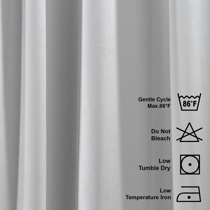 Gray velvet fabric with laundry care labels on a white background