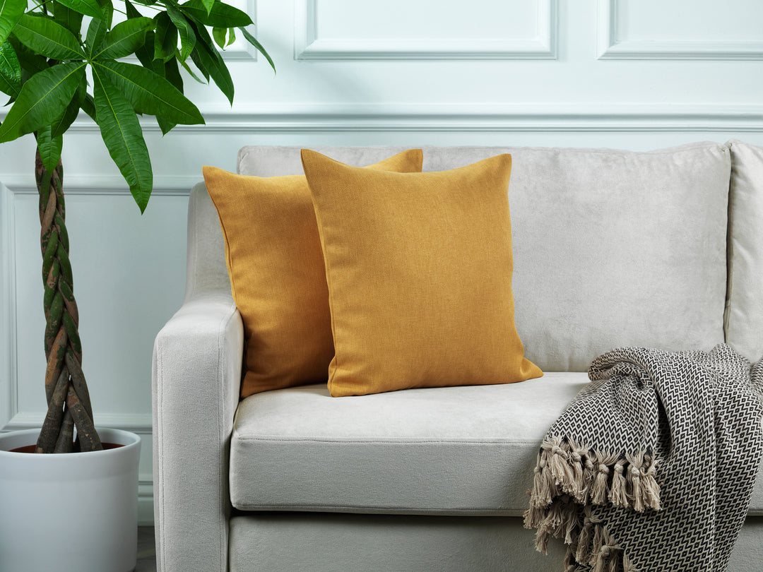 A made to measure cushion cover in warm mustard linen‑look fabric, displaying a soft woven texture and neatly finished seams for a vibrant contemporary finish