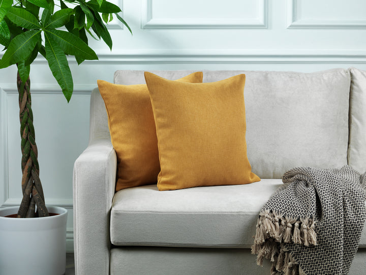 A made to measure cushion cover in warm mustard linen‑look fabric, displaying a soft woven texture and neatly finished seams for a vibrant contemporary finish
