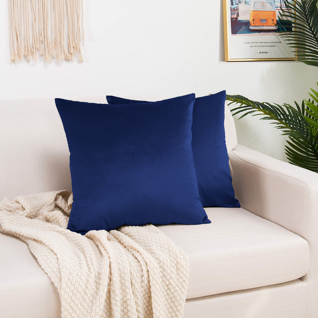 A made to measure cushion cover in deep navy‑blue shiny velvet, shown with a reflective plush surface and clean structured edges for a rich premium finish