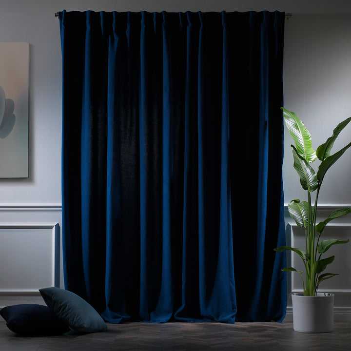 Navy blue velour curtains photographed at night, showing deep tone, dense weave and elegant soft drape.