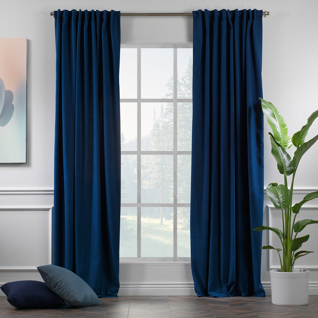 Navy blue velour curtains shown in daylight, highlighting smooth pile texture and rich colour saturation.