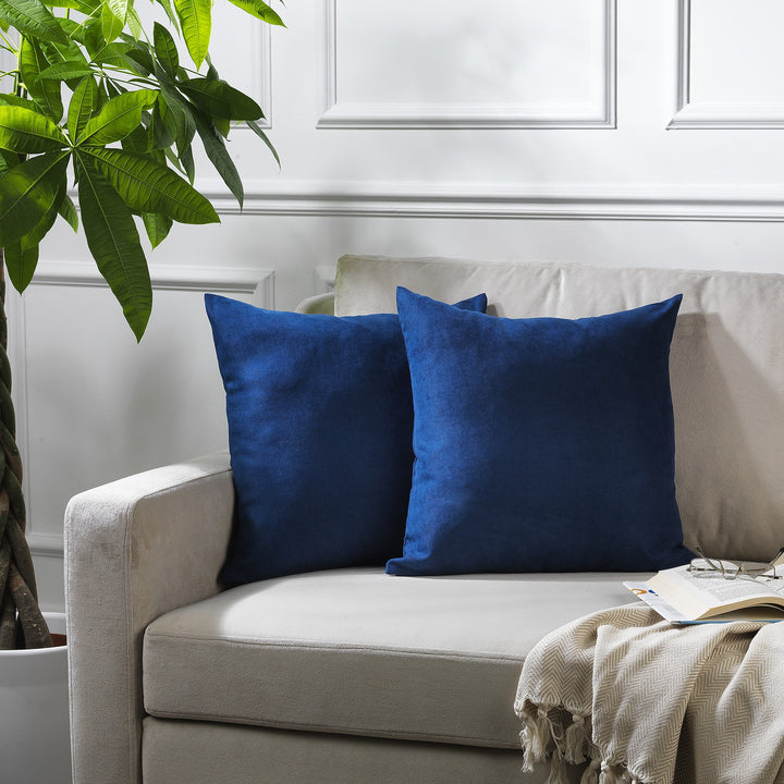 A made to measure cushion cover in deep navy velour, featuring a soft plush surface and neatly finished seams for a rich refined finish