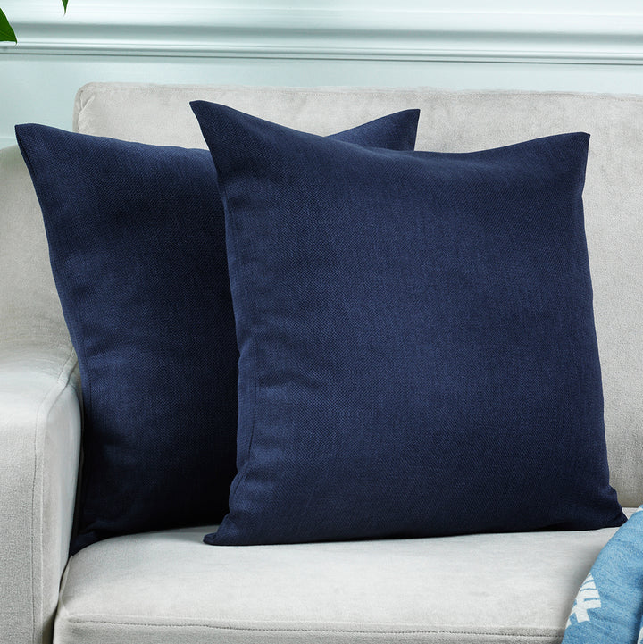 A made to measure cushion cover in deep navy linen‑look fabric, featuring a subtle woven texture and clean structured seams for a rich elegant appearance