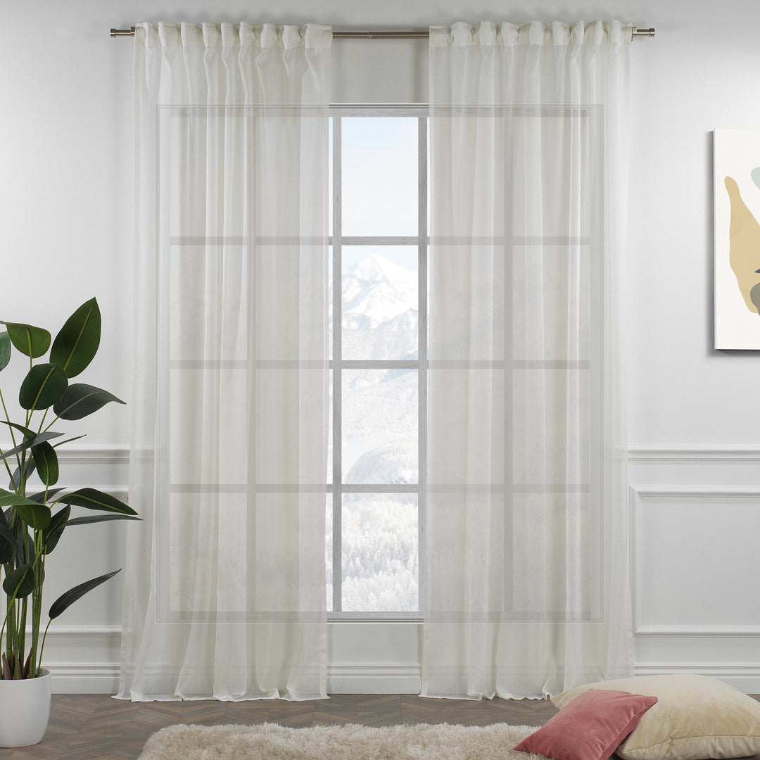 Off‑white linen sheer curtain with rod‑pocket header in a neutral living room, soft natural light and airy drape.