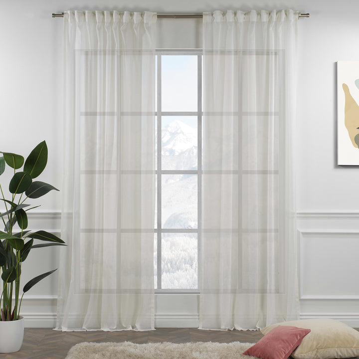 Off‑white linen sheer curtain with rod‑pocket header in a neutral living room, soft natural light and airy drape.