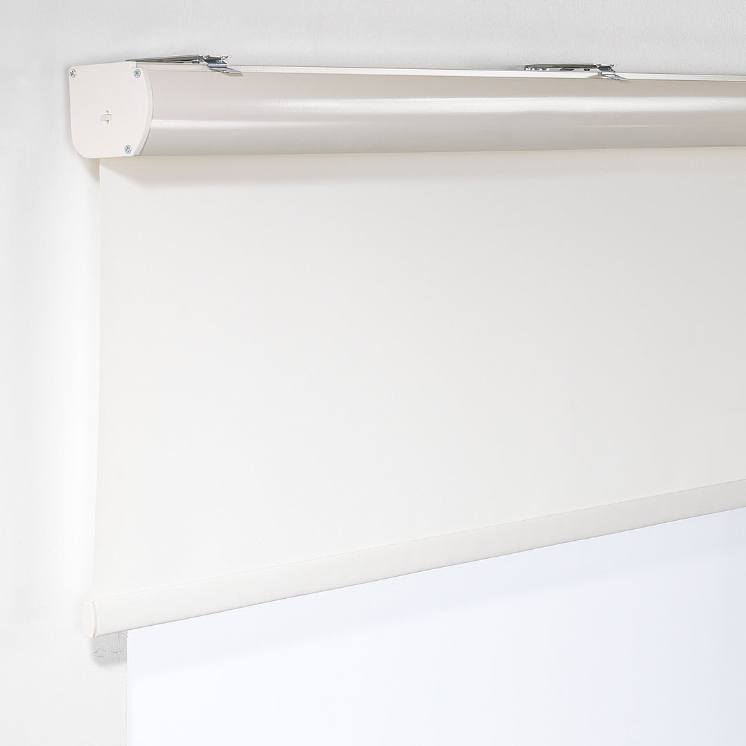 An off‑white room darkening roller blind made to measure, photographed with a smooth matte finish and refined minimal styling