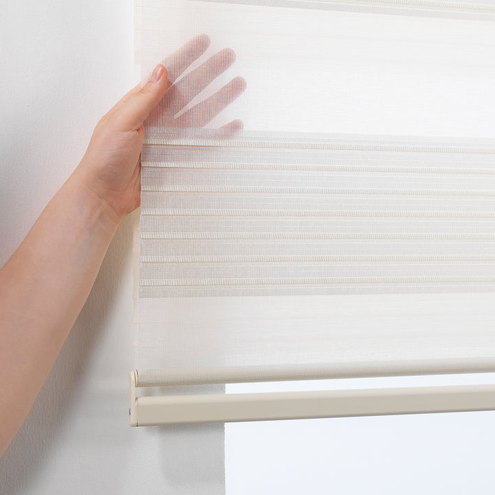 Made to measure off‑white thick pleated linen‑textured zebra roller blind featuring layered sheer and dim‑out stripes for soft diffused light control and privacy, highlighting its rich fabric texture, premium pleated finish and contemporary day‑and‑night blind design.