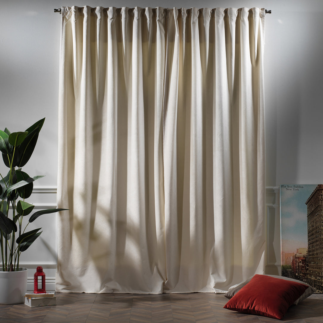 Off‑white matte velvet curtain featuring a soft smooth drape and muted velvety texture, offering gentle light reduction and a clean elegant look, highlighting its subtle off‑white tone and premium modern velvet finish.