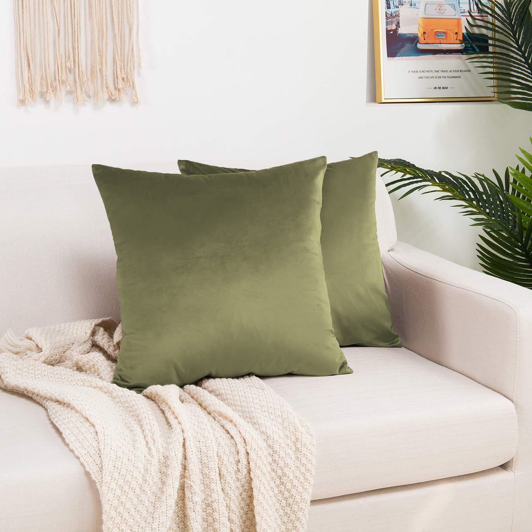 A made to measure cushion cover in warm olive‑green shiny velvet, shown with a soft reflective sheen and neatly tailored edges for a rich elegant finish