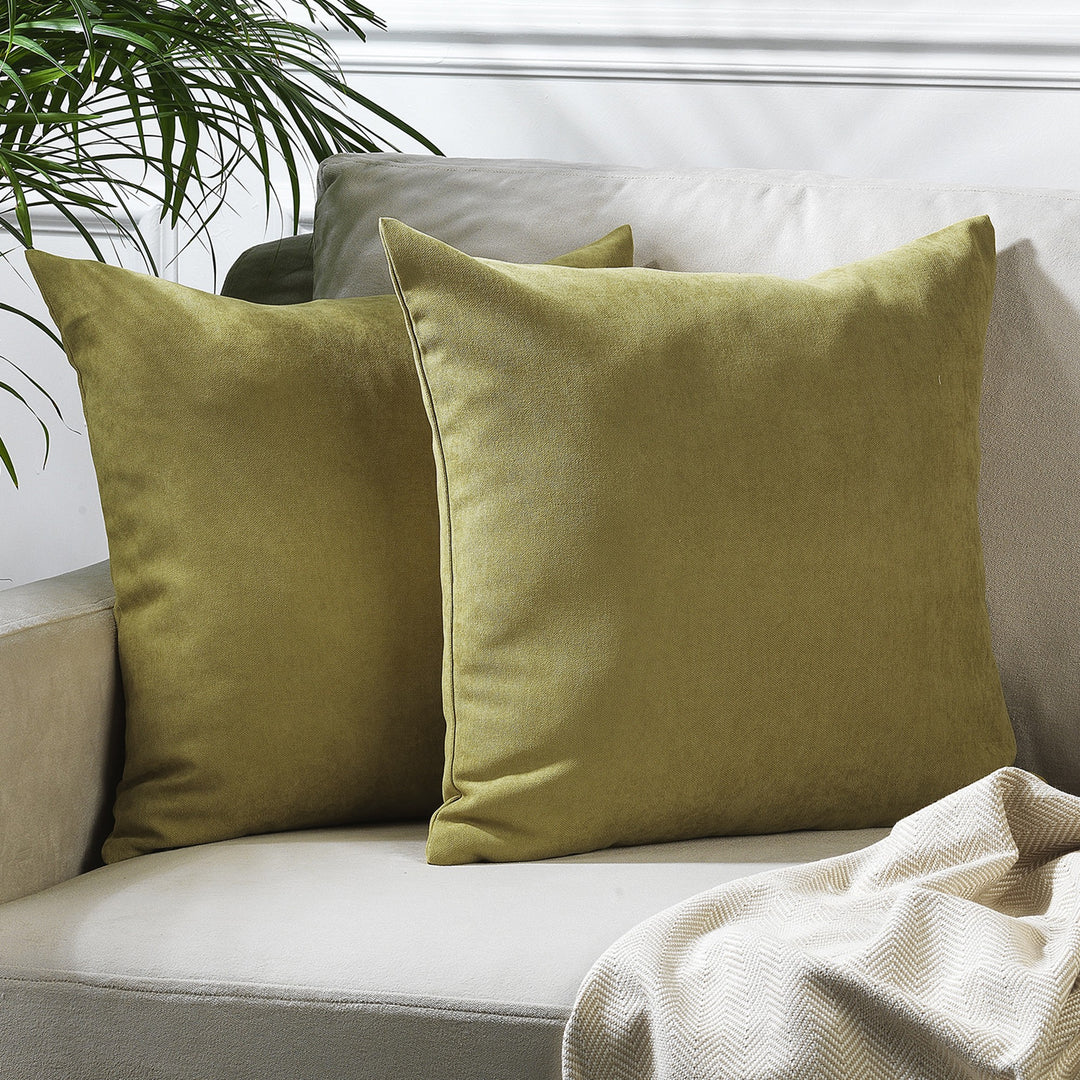 A made to measure cushion cover in warm olive velour, featuring a soft lightweight texture and neatly tailored seams for a refined earthy look