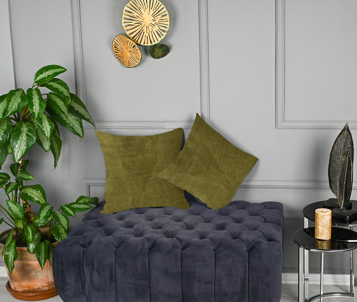 A made to measure cushion cover in warm olive matte velvet, displaying a velvety surface and neatly tailored edges for a rich earthy appearance