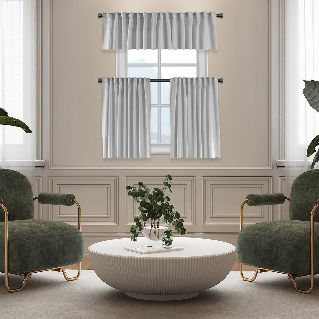 Living room with green armchairs, a white coffee table, and striped curtains.