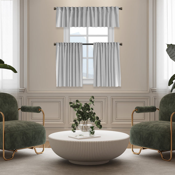 Living room with green armchairs, a white coffee table, and striped curtains.