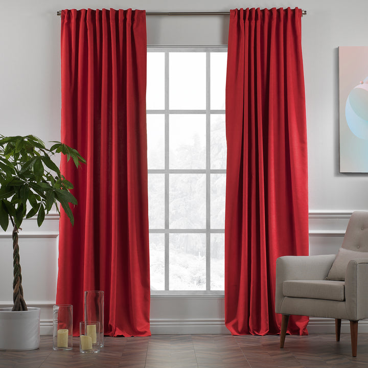 Red velour curtains shown in daylight, highlighting rich saturated tone, smooth pile texture and elegant drape, made to measure and available by the metre.