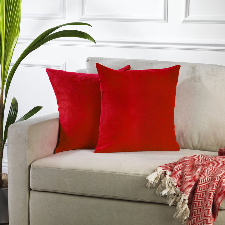 A made to measure cushion cover in classic red velour, featuring a lightweight velvety surface and crisp seams for a bold premium appearance