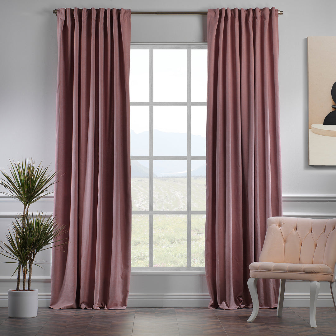 Rose pink velour curtains shown in daylight, highlighting smooth pile texture, warm pink tone and elegant drape, made to measure and available by the metre.
