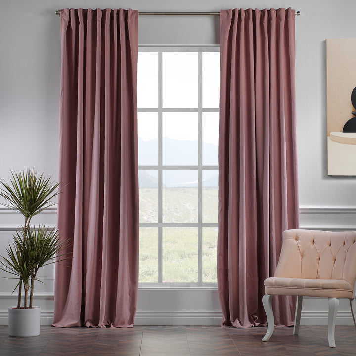 Rose pink velour curtains shown in daylight, highlighting smooth pile texture, warm pink tone and elegant drape, made to measure and available by the metre.