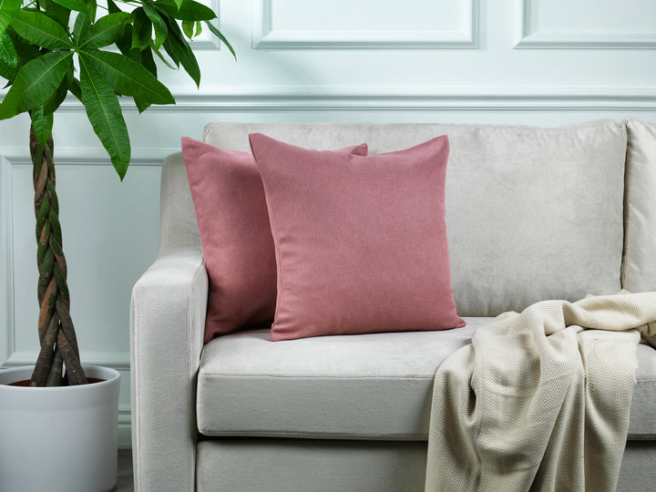 A made to measure cushion cover in soft rose‑pink linen‑look fabric, displaying a gentle woven texture and clean seams for a delicate premium appearance