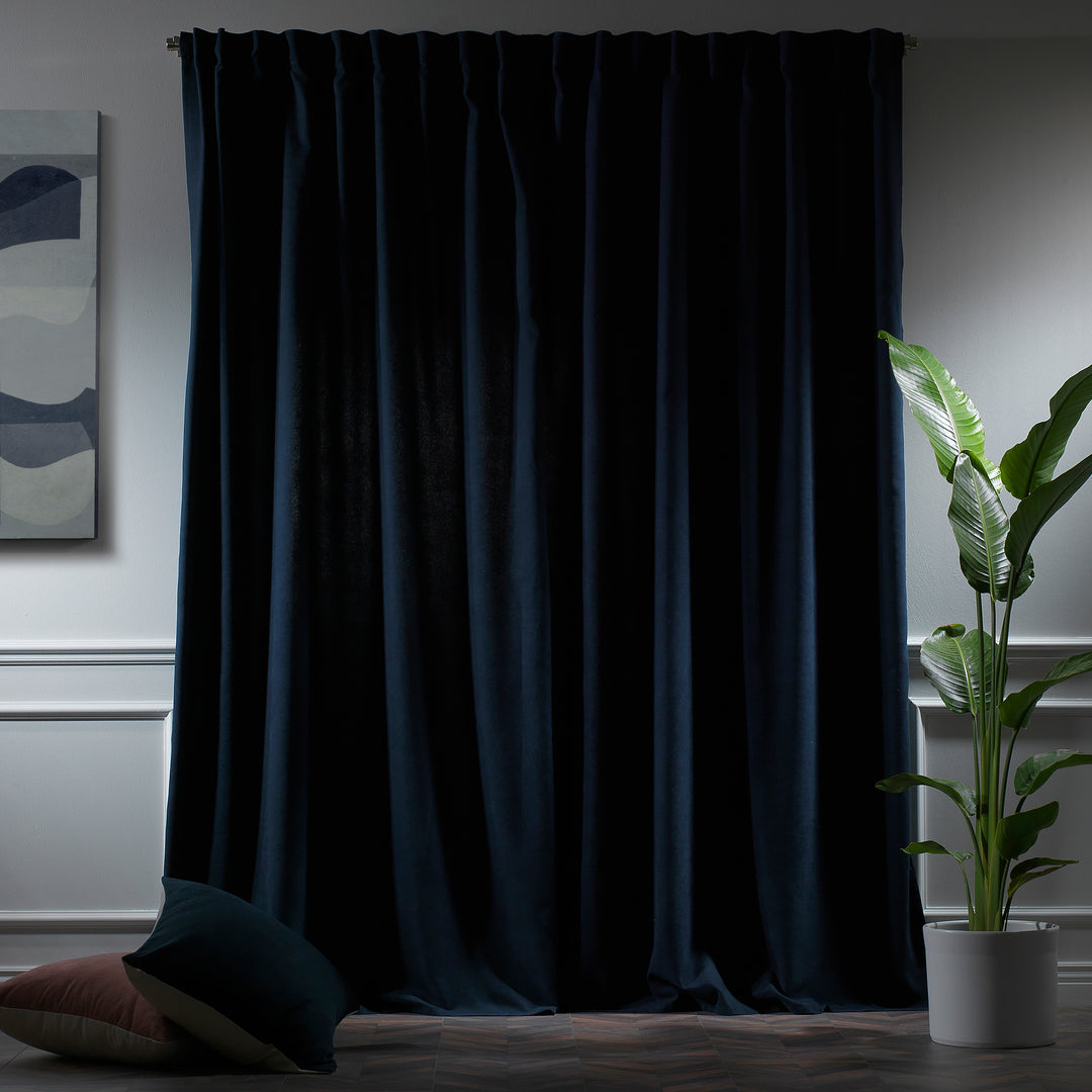 Royal blue velour curtains photographed at night, showing deep tone, dense weave and refined matte finish, made to measure and available by the metre.
