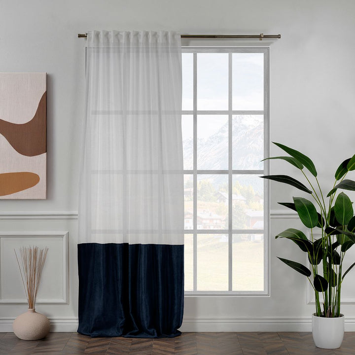 A made to measure royal blue velvet and sheer block curtain, featuring deep colour contrast, soft folds and a premium layered look