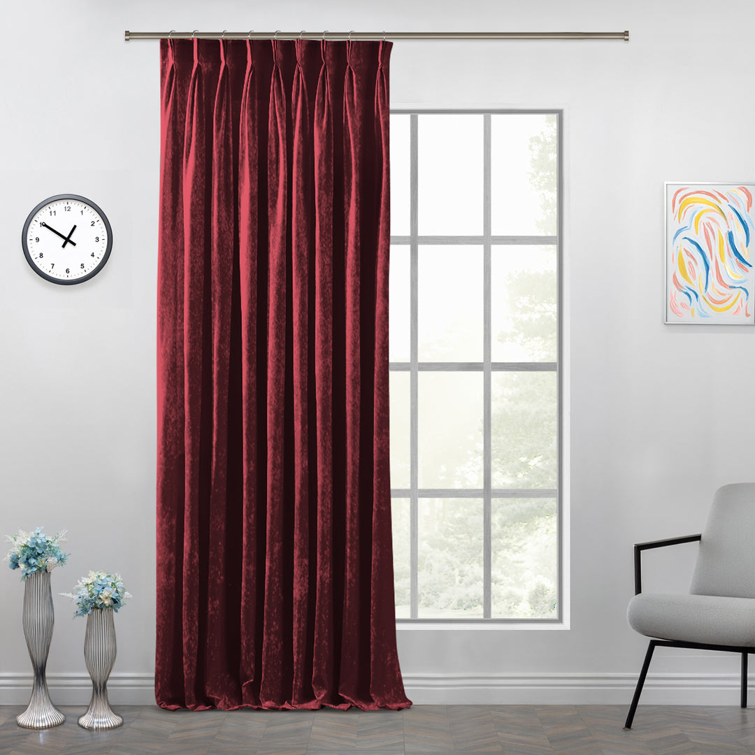 Shiny velvet pinch pleat curtain with luminous folds and a long, sculpted tailored drop