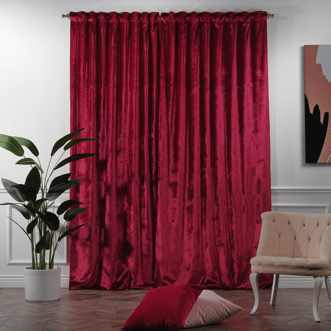 Shiny velvet pinch pleat curtain with luminous folds and a long, sculpted tailored drop