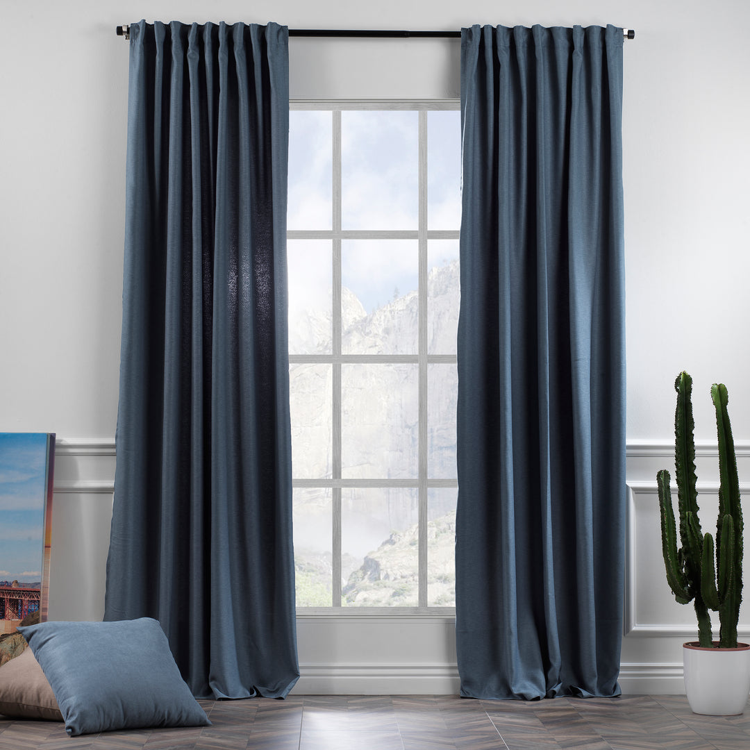 A made to measure linen‑look curtain in soft sky blue, shown in natural daylight with smooth drape and clean tailored pleats
