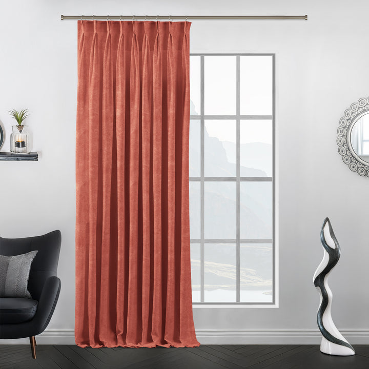 Blush coral pinch pleat velvet curtain with tailored folds.