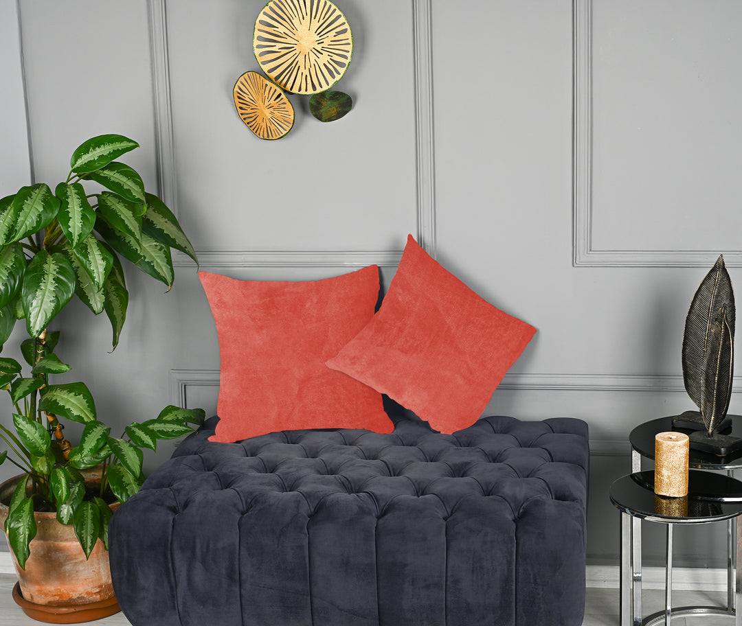 A made to measure cushion cover in soft salmon‑pink matte velvet, featuring a gentle velvety surface and refined seams for a warm delicate look
