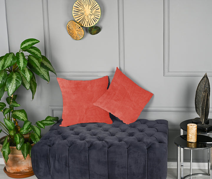 A made to measure cushion cover in soft salmon‑pink matte velvet, featuring a gentle velvety surface and refined seams for a warm delicate look