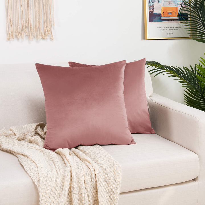 A made to measure cushion cover in deep sangria‑red shiny velvet, displaying a glossy plush texture and neatly finished seams for a rich sophisticated appearance