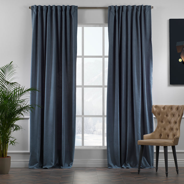 Sky blue velour curtains shown in daylight, highlighting smooth pile texture and fresh blue tone, made to measure and available by the metre.