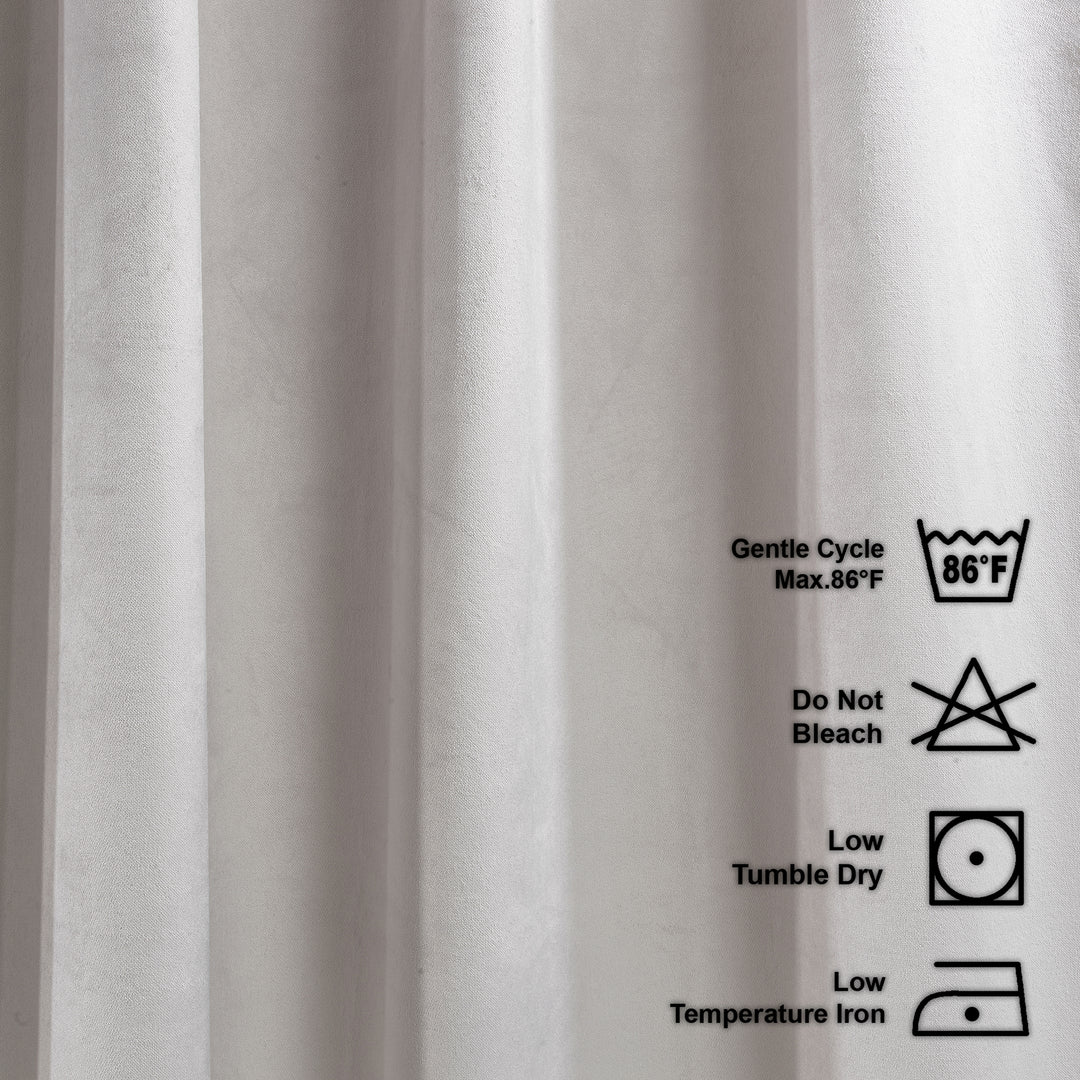Close-up of fabric with laundry care labels on a white background