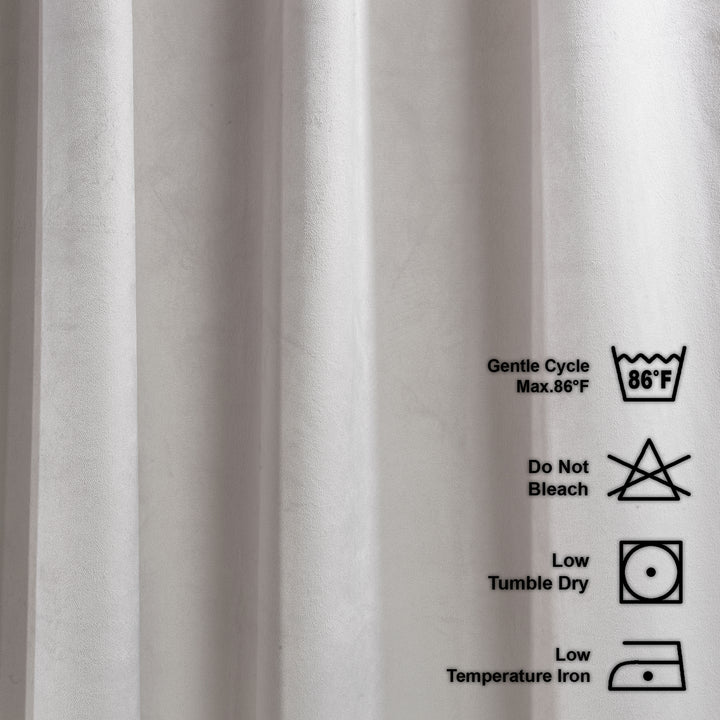 Close-up of fabric with laundry care labels on a white background