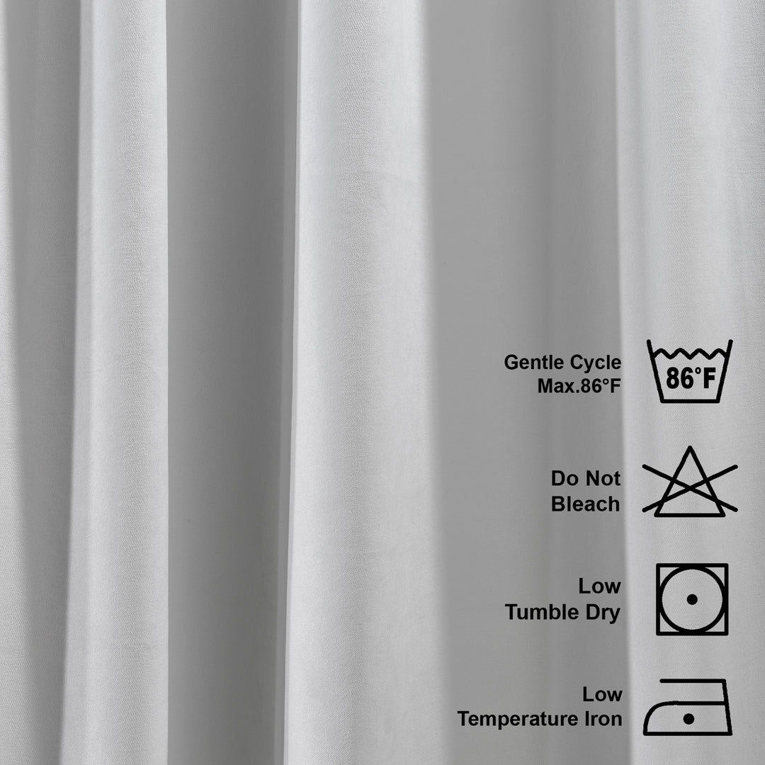 A close view of the washing label for the matte velvet kitchen valance, showing care instructions and neatly finished inner stitching
