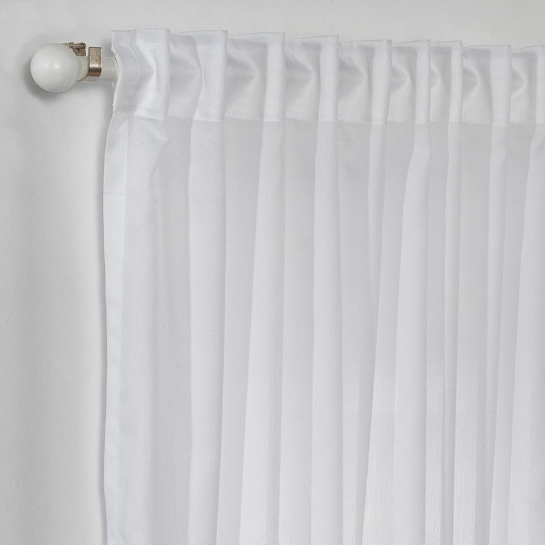Close‑up of White silk‑crepe  curtain showing fine crepe texture, refined pleated header and soft translucent light, made to measure