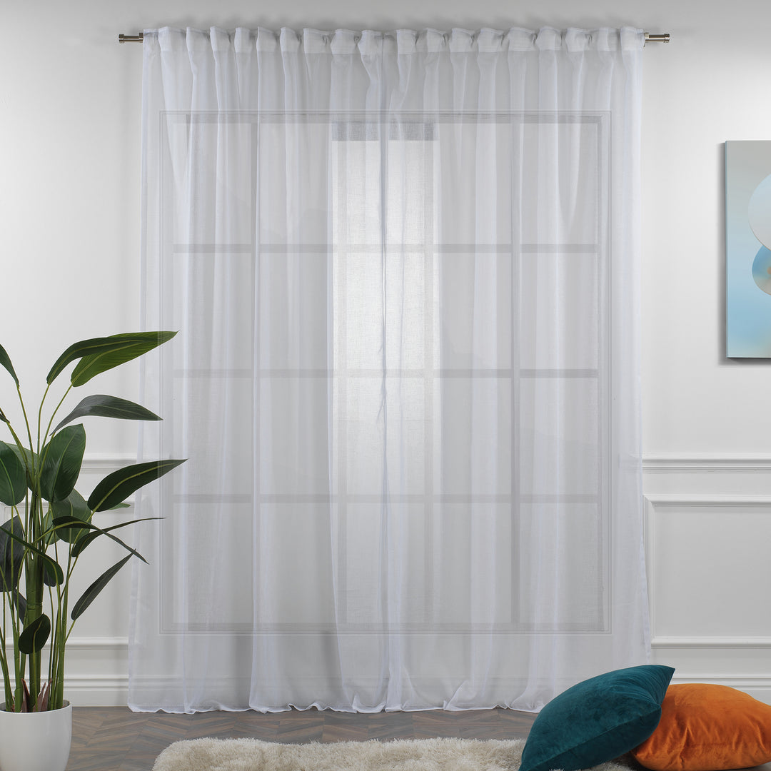 White linen sheer curtain fully closed in a bright living room, crisp airy folds and clean semi‑sheer texture.