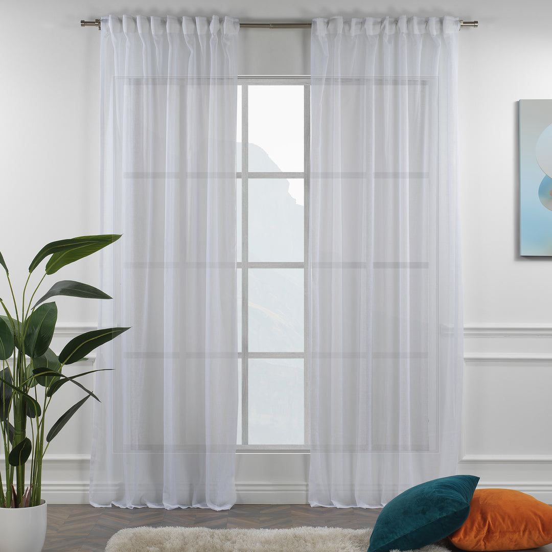 White linen sheer curtain with rod‑pocket header in a bright living room, clean airy transparency and soft folds.