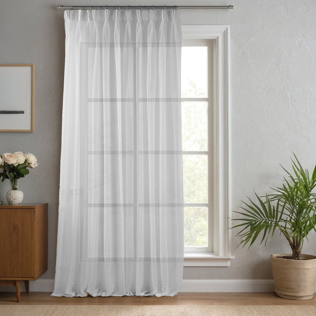White linen‑sheer curtain made to measure with clean pinch pleats and bright airy transparency.