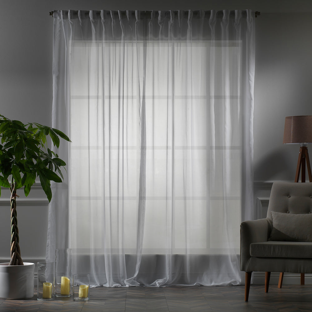 Made‑to‑measure extra‑long and extra‑wide White silk‑crepe sheer curtain in evening light, highlighting the fine crepe weave and gentle soft‑glow translucency
