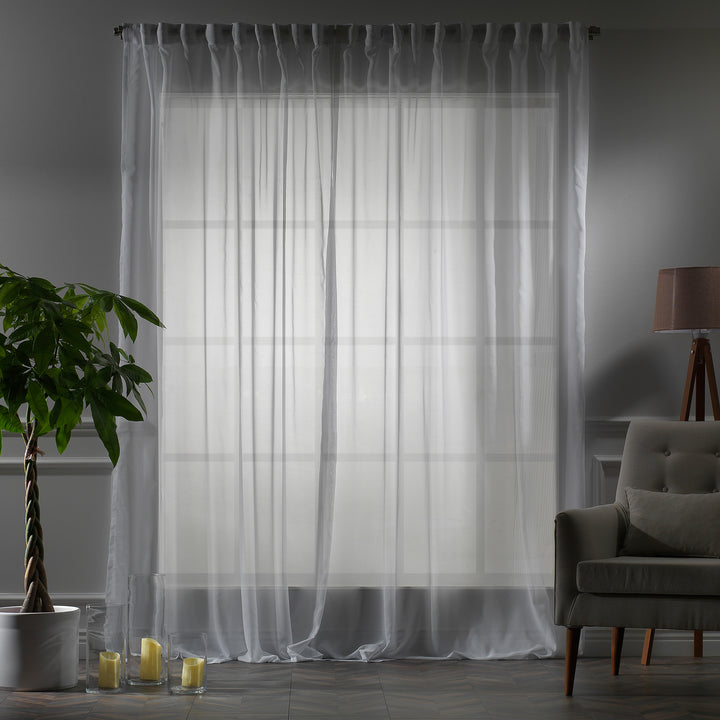 Made‑to‑measure extra‑long and extra‑wide White silk‑crepe sheer curtain in evening light, highlighting the fine crepe weave and gentle soft‑glow translucency