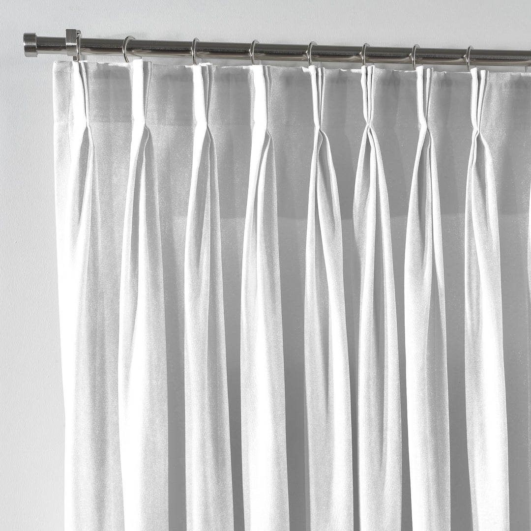 Close‑up of white velvet fabric with delicate pinch pleated detail and a smooth, modern finish.