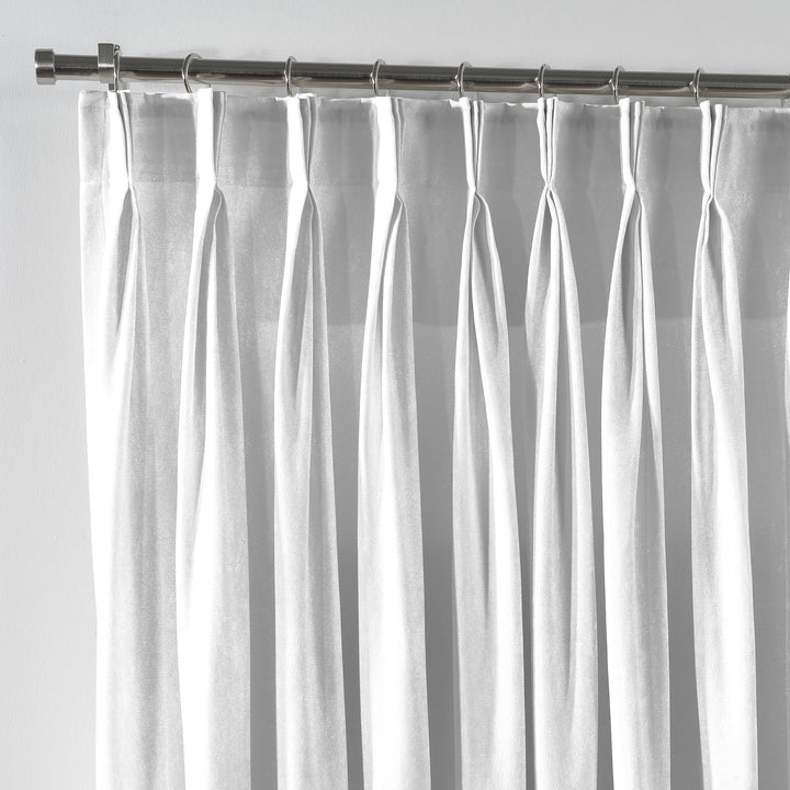Close‑up of white velvet fabric with delicate pinch pleated detail and a smooth, modern finish.