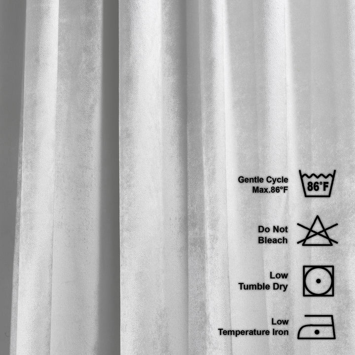 Close-up of a shiny velvet with washing instructions on a white background